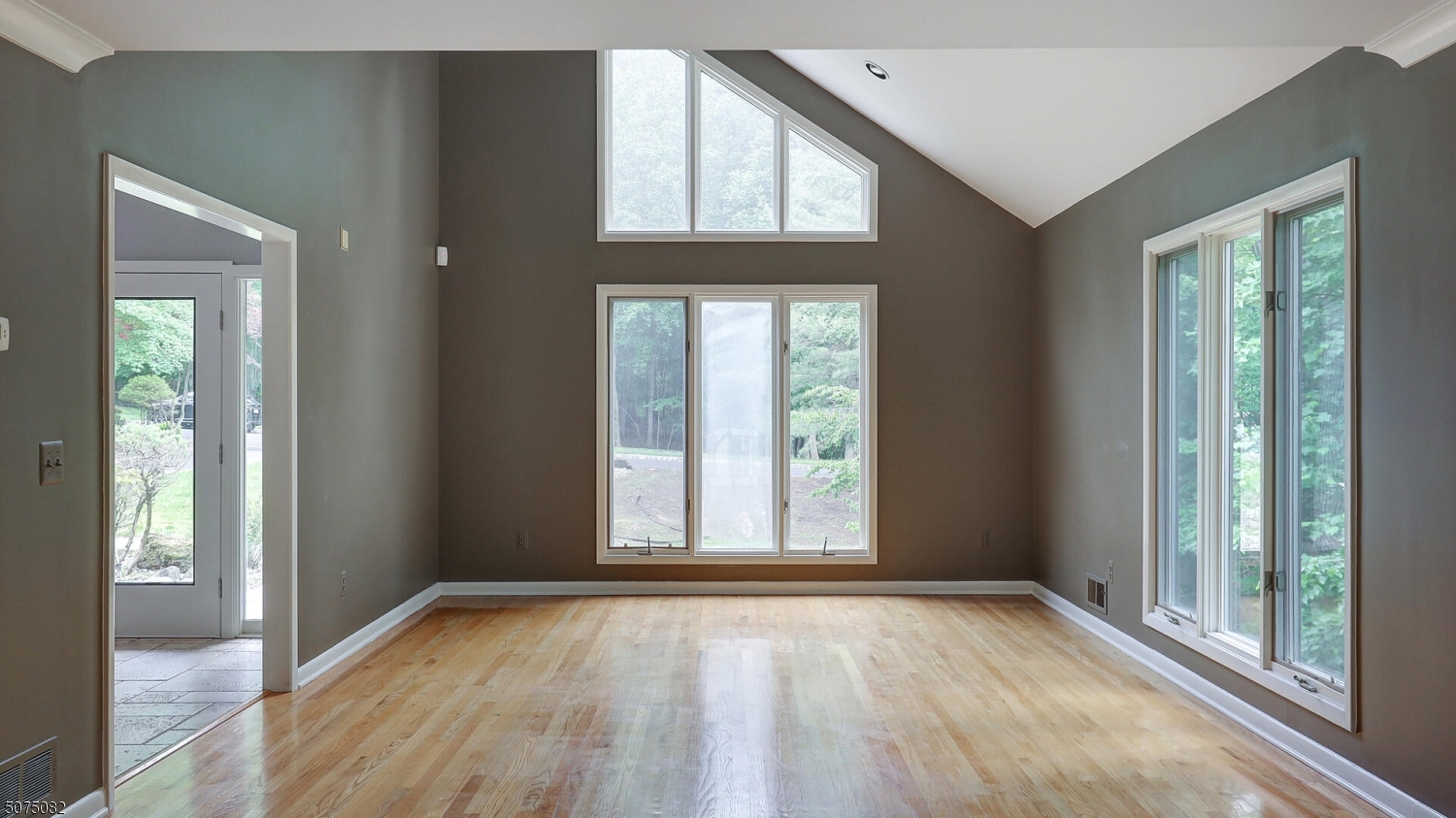17 Adams Road Bridgewater, NJ 08836 - Photo 4 of 25 an empty room with wooden floor and windows