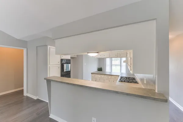 a kitchen with granite countertop a sink and a stove top oven