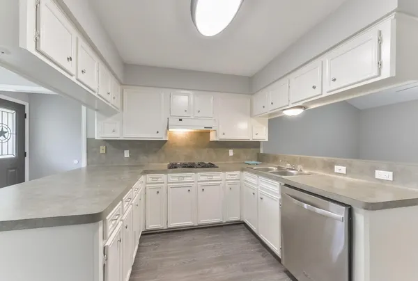 a kitchen that has a sink and a stove in it