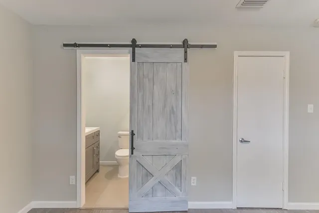 a bathroom with a toilet and a shower