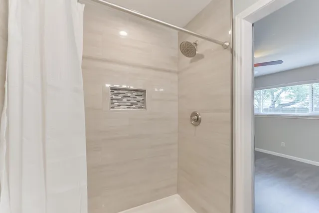 a bathroom with a shower and a sink