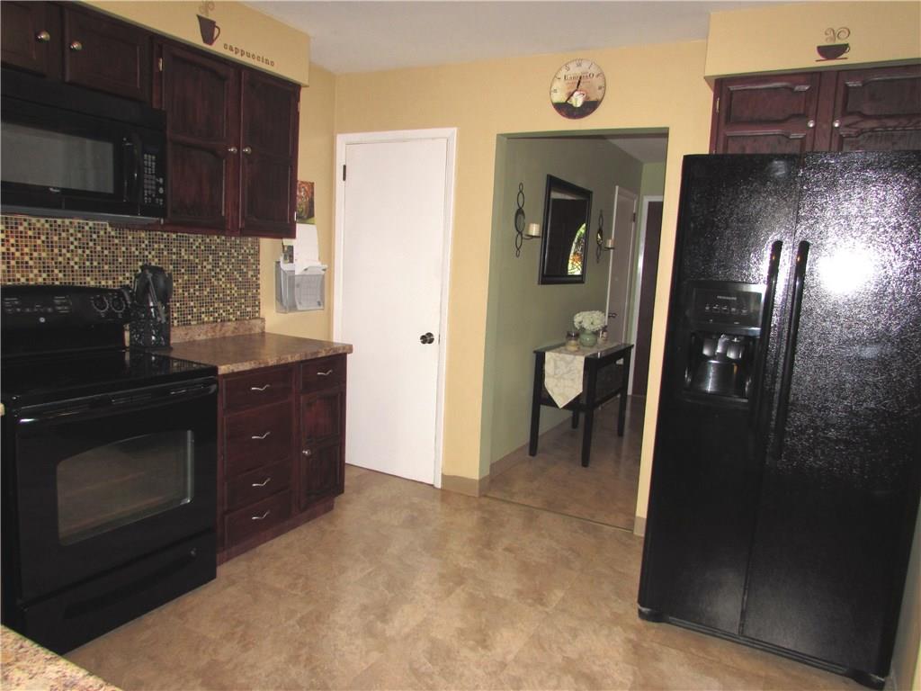 411 Beech Road Plum, PA 15239 - Photo 13 of 25 The Kitchen has been Updated with a Newer Back Splash, Counter Tops, and Newer Appliances