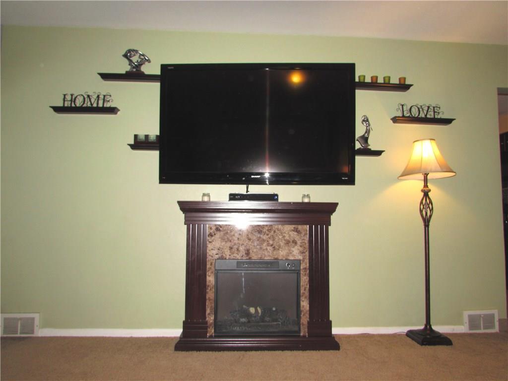 411 Beech Road Plum, PA 15239 - Photo 9 of 25 The Newer Electric Fireplace enhances the room with Beauty & Warmth
