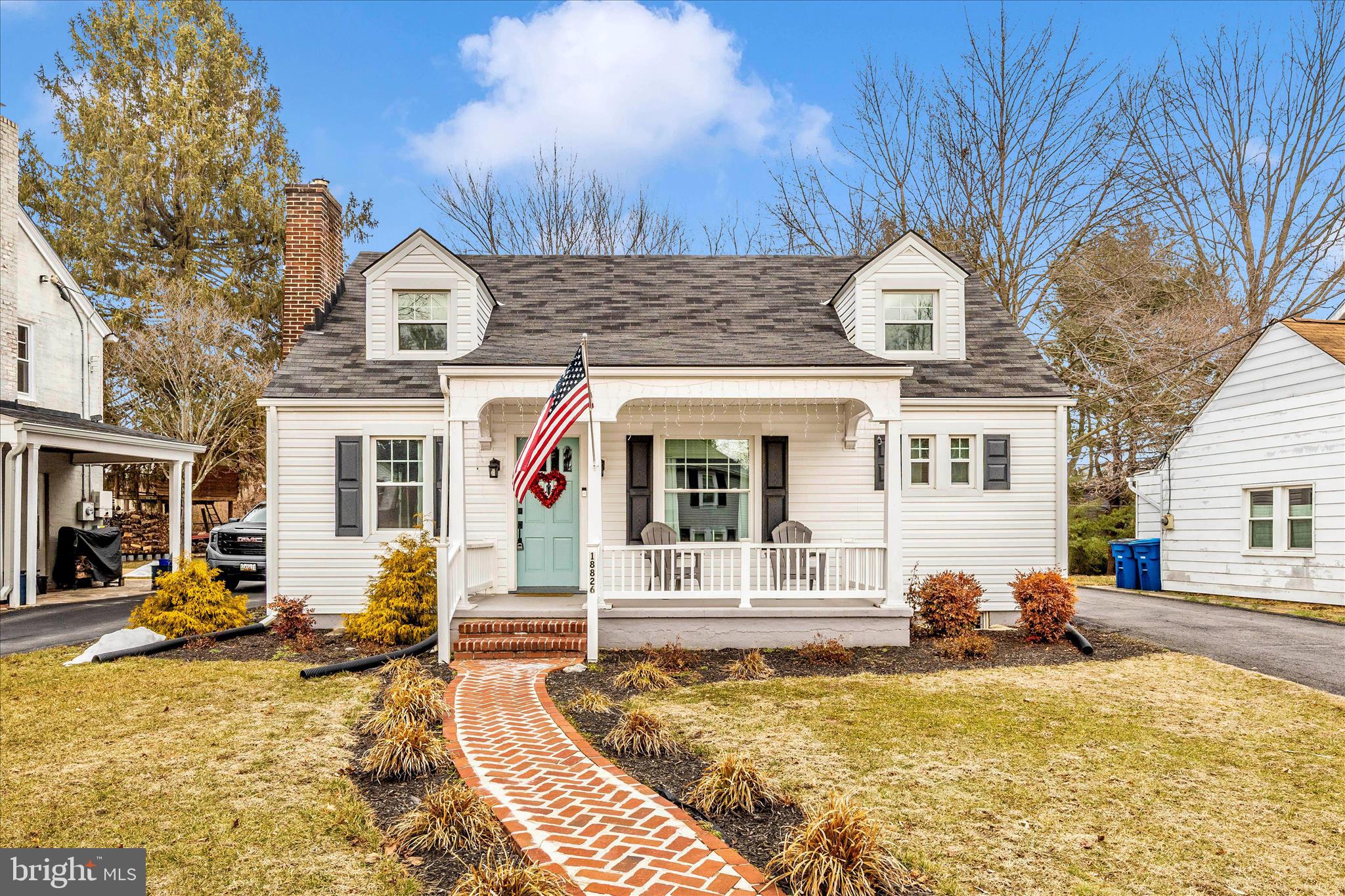 18826 Preston Road Hagerstown, MD 21742 - Photo 1 of 60 a view of a white house with large windows and a small yard
