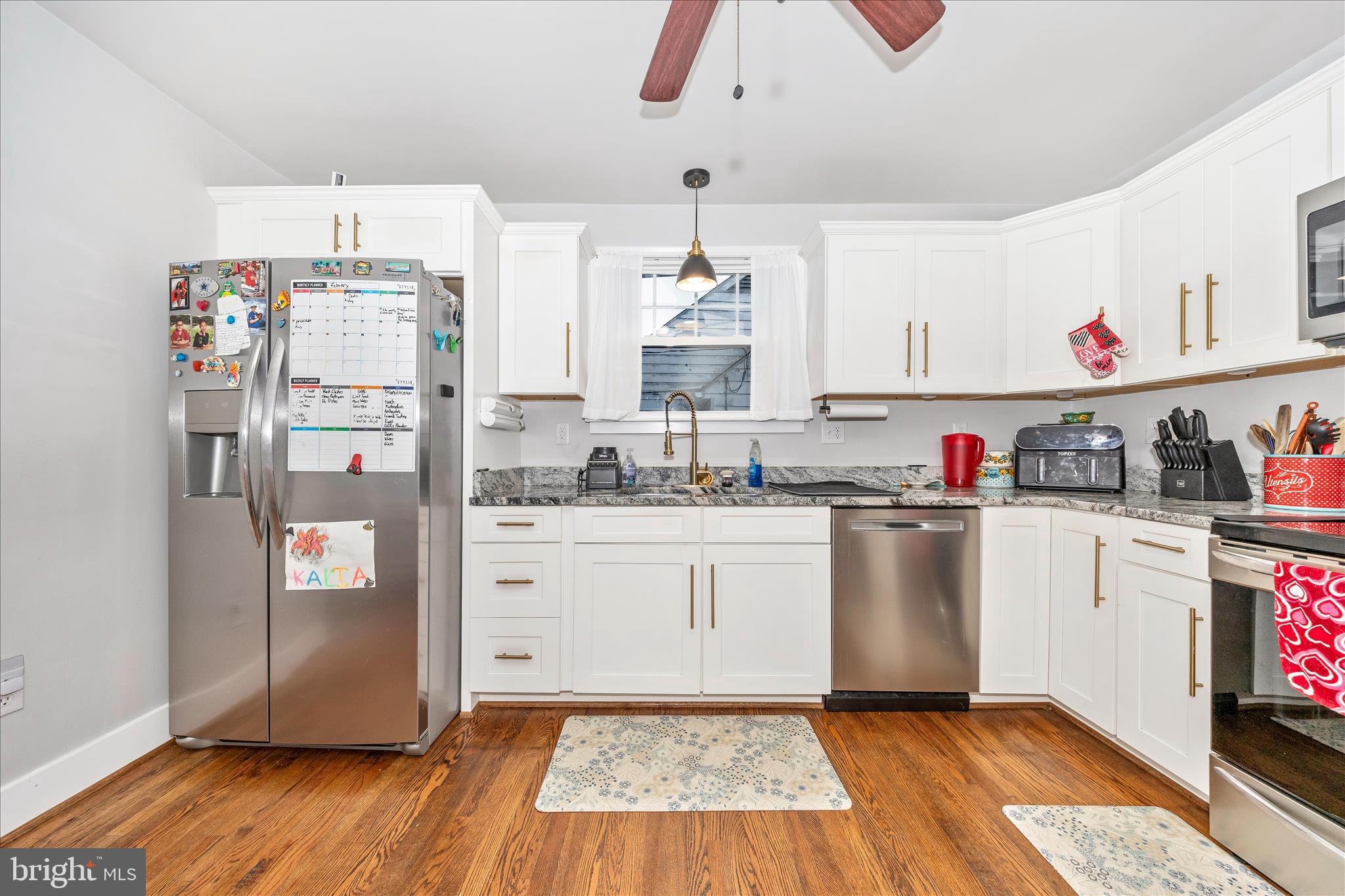 18826 Preston Road Hagerstown, MD 21742 - Photo 12 of 60 a kitchen with granite countertop a refrigerator and white cabinets