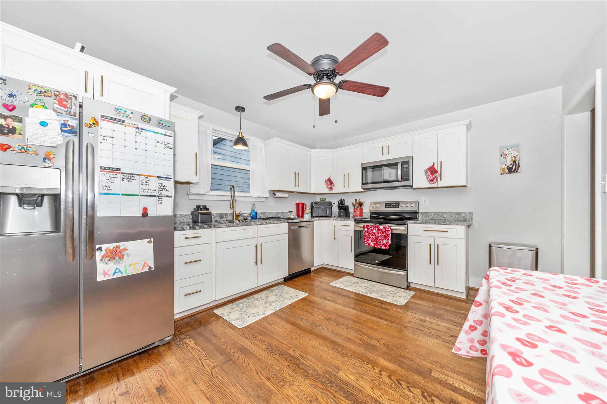 18826 Preston Road Hagerstown, MD 21742 - Photo 13 of 60 a kitchen with stainless steel appliances kitchen island granite countertop a refrigerator and microwave