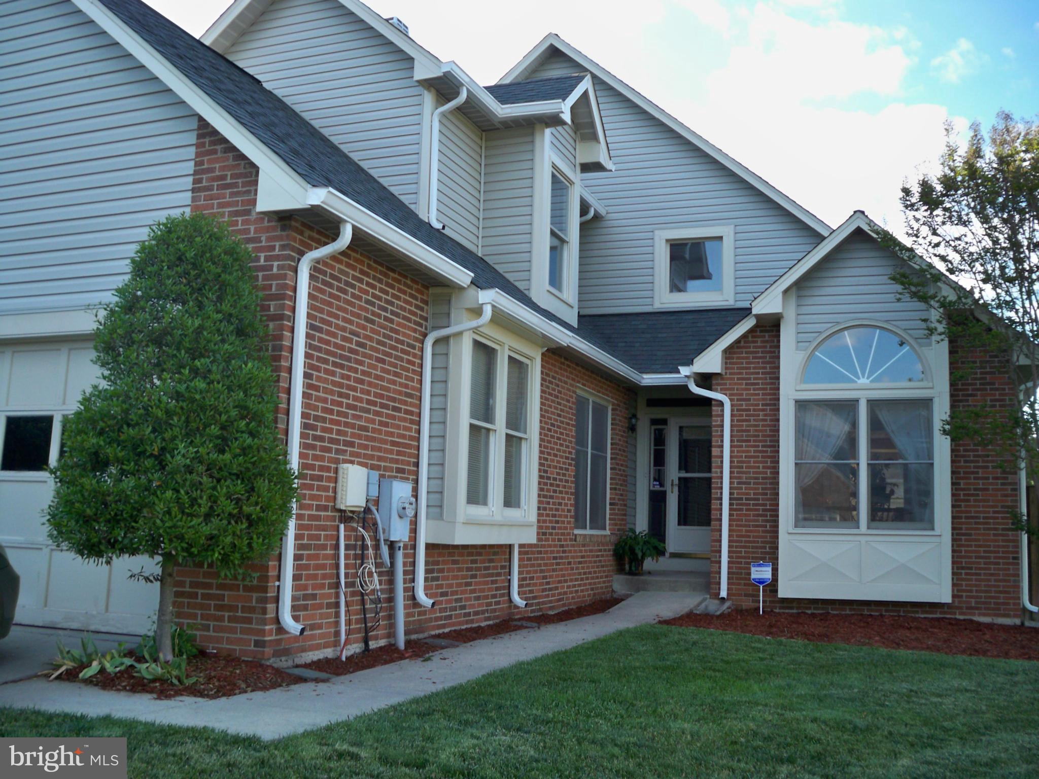 14228 Summit Lane Laurel, MD 20708 - Photo 2 of 30 a front view of a house with a garden