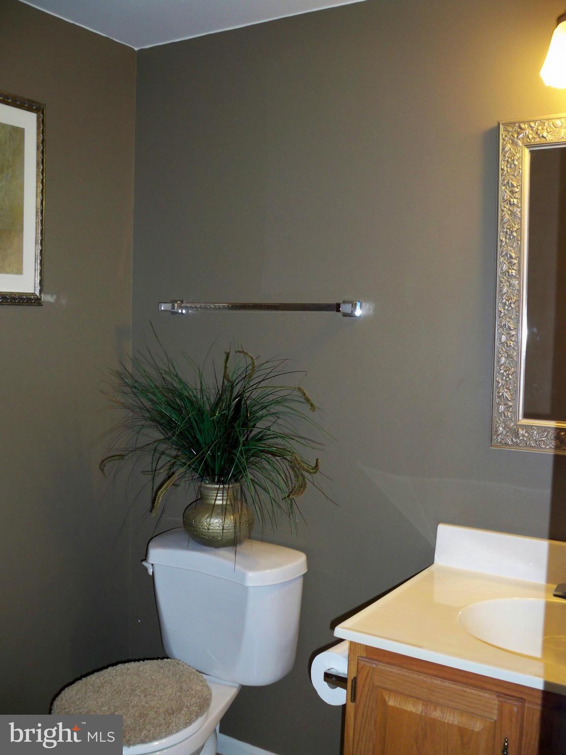 14228 Summit Lane Laurel, MD 20708 - Photo 12 of 30 a bathroom with a toilet a sink and a mirror