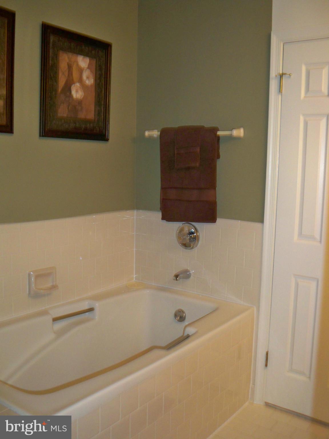 14228 Summit Lane Laurel, MD 20708 - Photo 16 of 30 a bathroom with a bathtub and a toilet