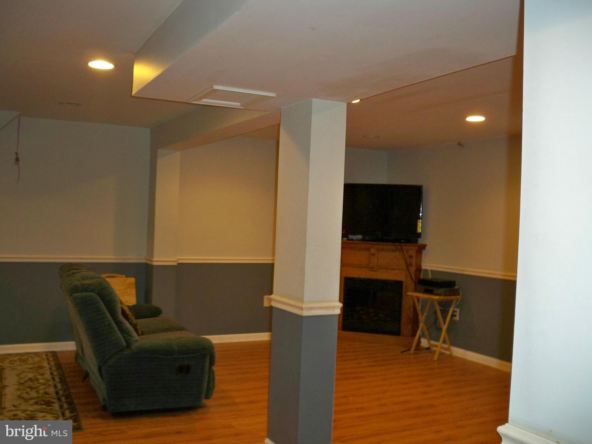 14228 Summit Lane Laurel, MD 20708 - Photo 22 of 30 a living room with furniture and a flat screen tv