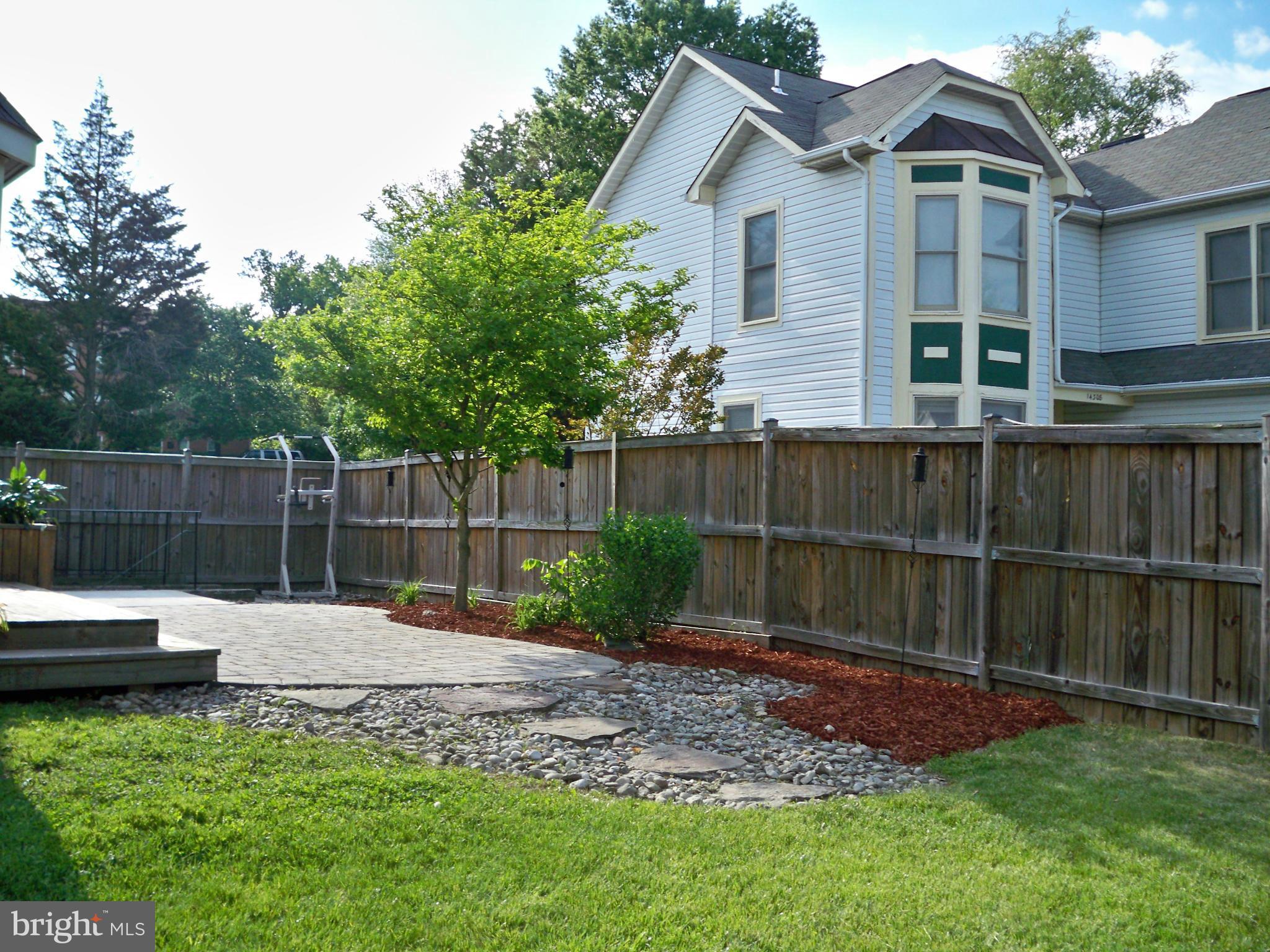 14228 Summit Lane Laurel, MD 20708 - Photo 27 of 30 a backyard of a house with table and chairs
