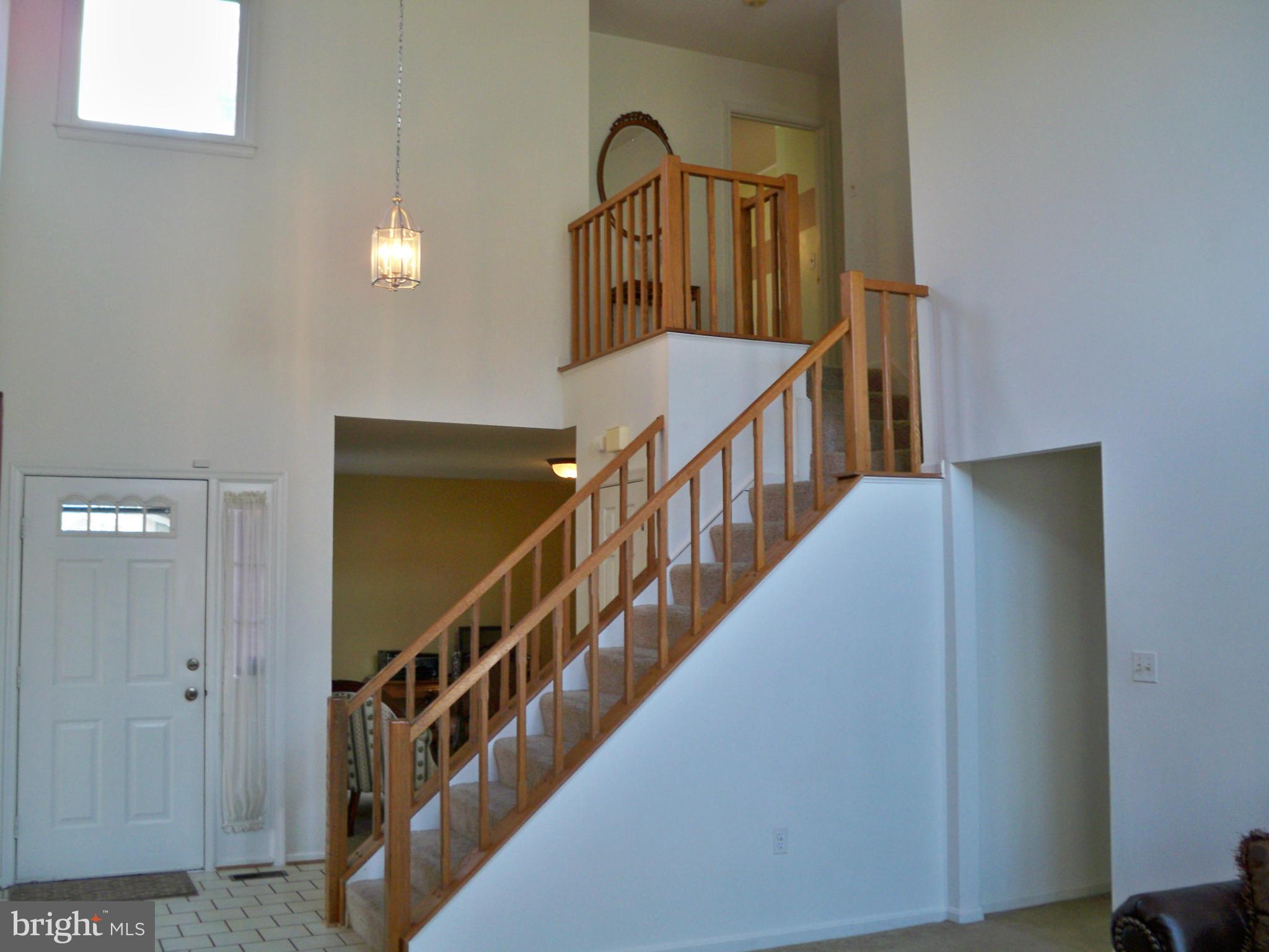 14228 Summit Lane Laurel, MD 20708 - Photo 4 of 30 a view of staircase with lots of frames on wall and windows