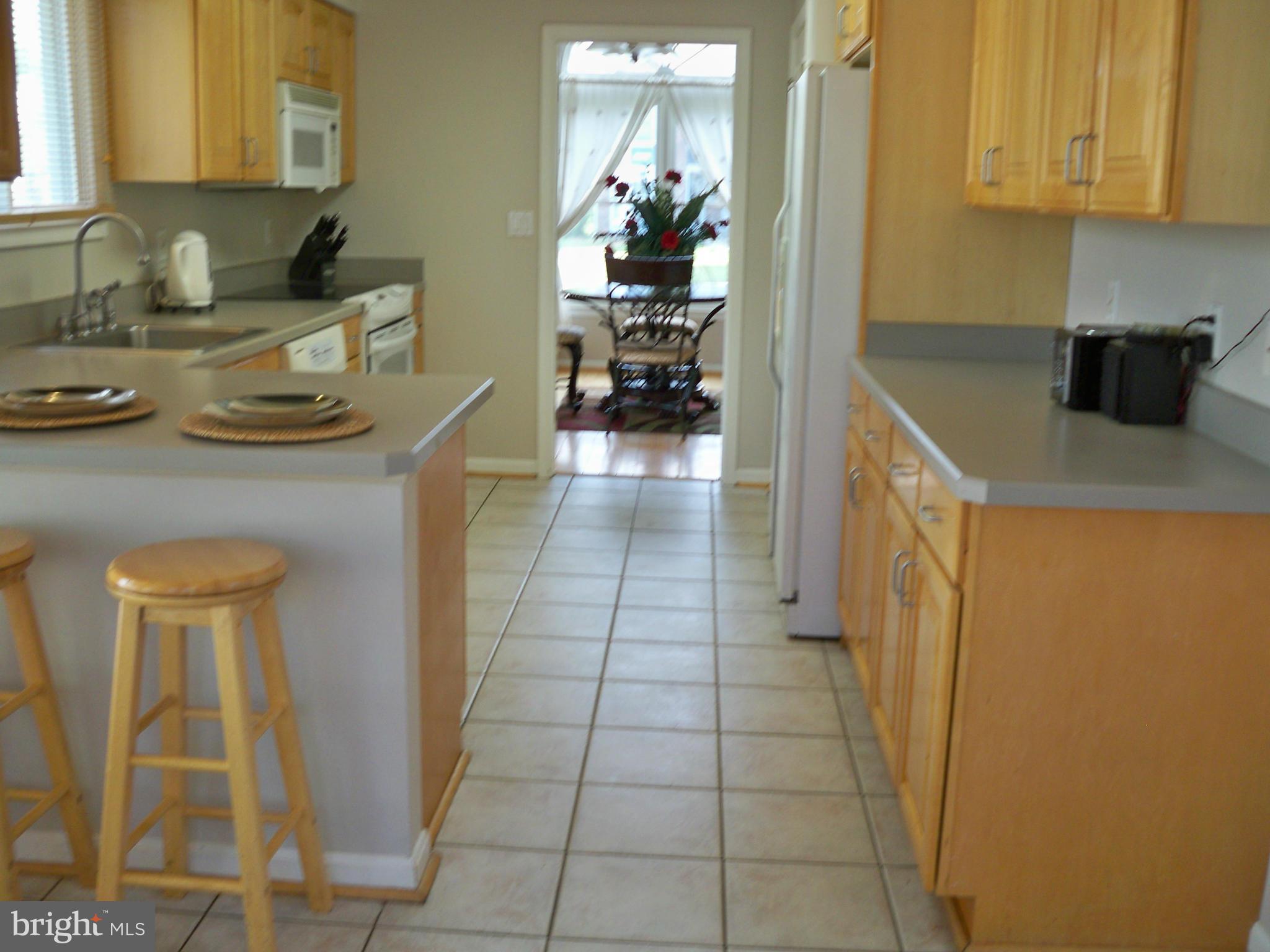 14228 Summit Lane Laurel, MD 20708 - Photo 7 of 30 a kitchen with a sink and cabinets