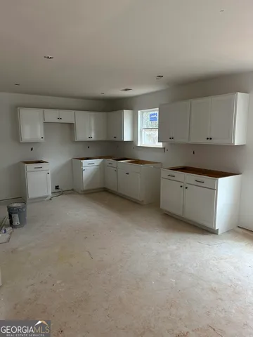 a large kitchen with a stove a sink dishwasher and a cabinets
