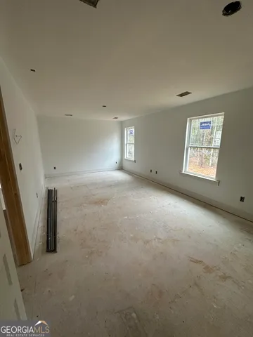 an empty room with a empty space and windows