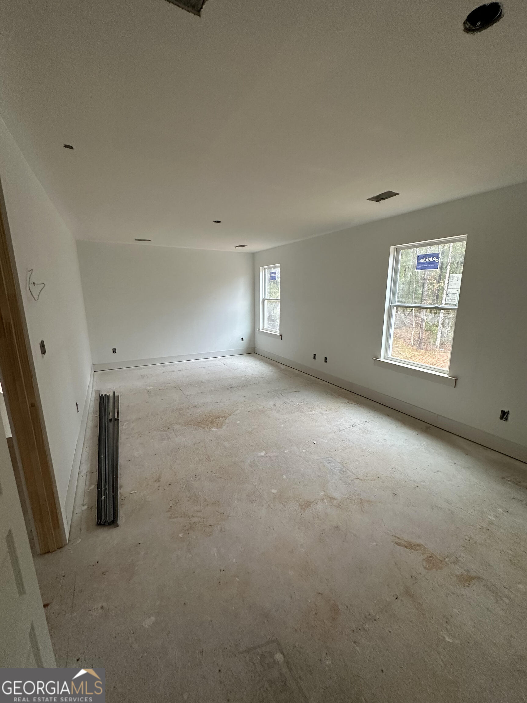 119 Kuhn Moore Road Locust Grove, GA 30248 - Photo 5 of 11 an empty room with a empty space and windows