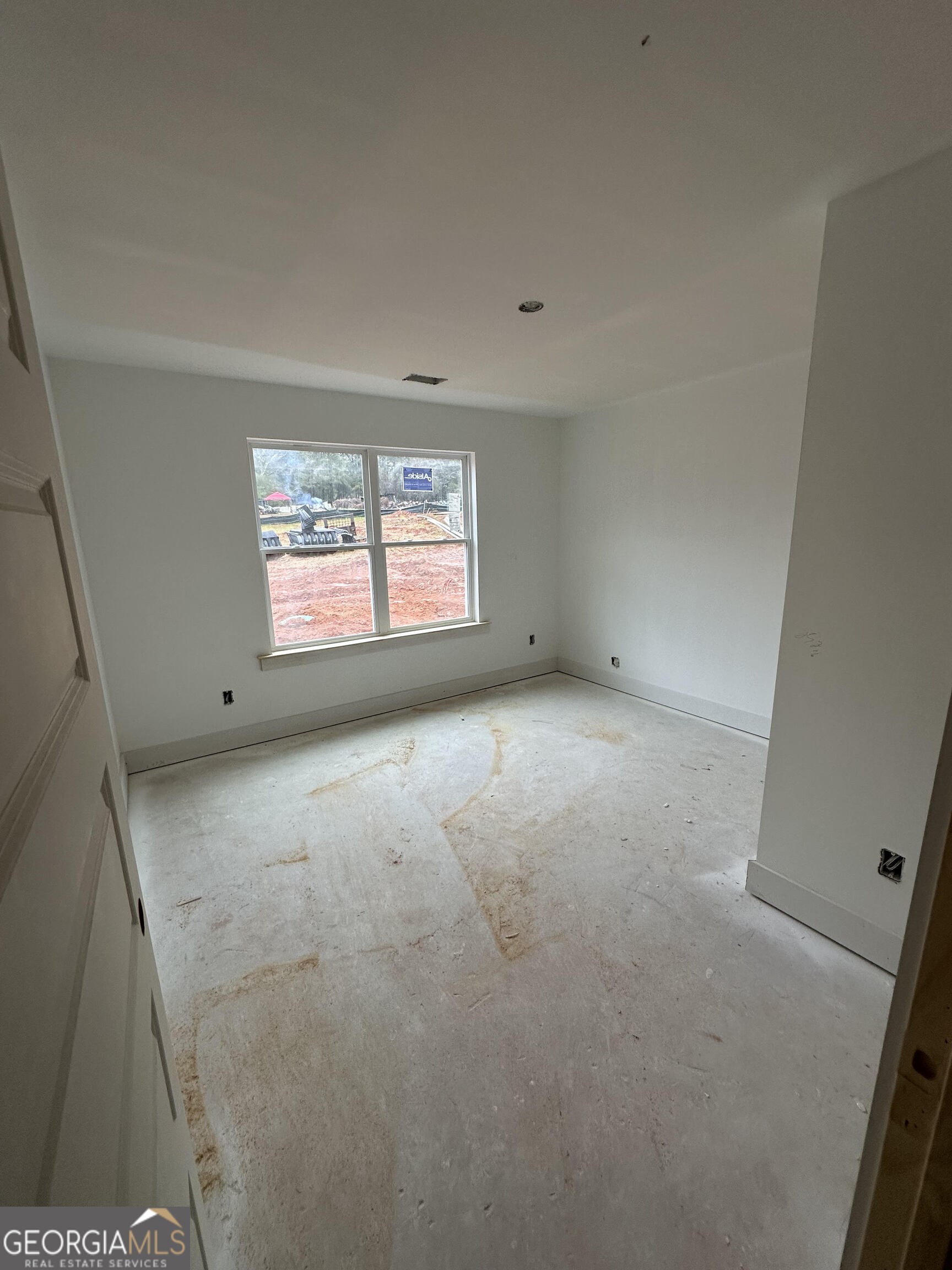 119 Kuhn Moore Road Locust Grove, GA 30248 - Photo 9 of 11 an empty room with windows