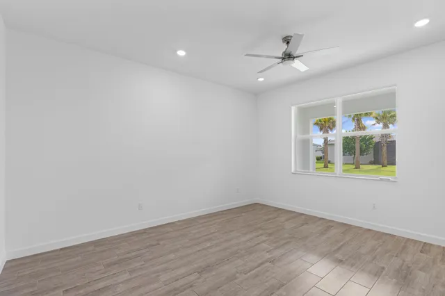 wooden floor in an empty room with a window