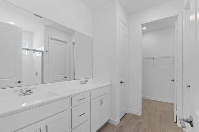 a bathroom with a double vanity sink and mirror