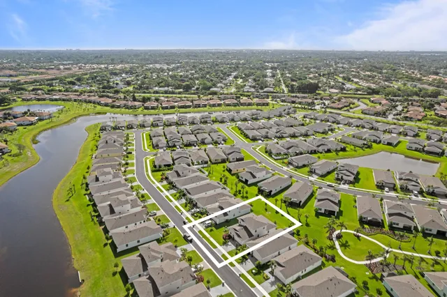 an aerial view of residential building and lake