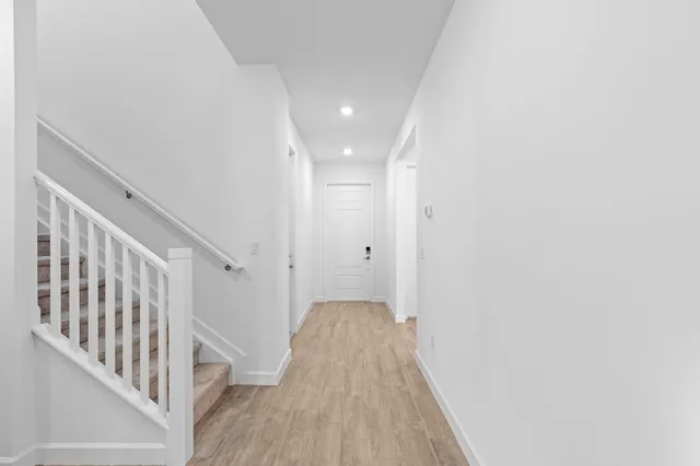 a view of a hallway with wooden floor