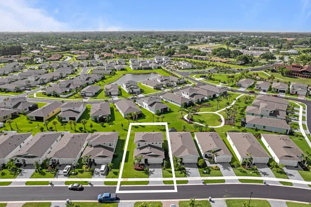 an aerial view of residential houses with outdoor space