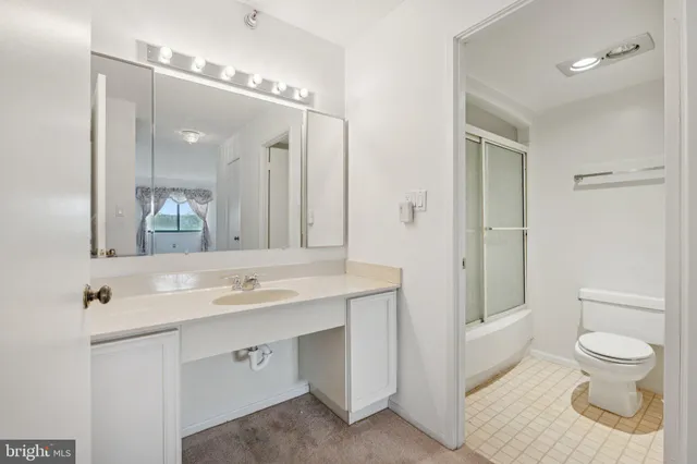 a bathroom with a toilet a sink and a mirror