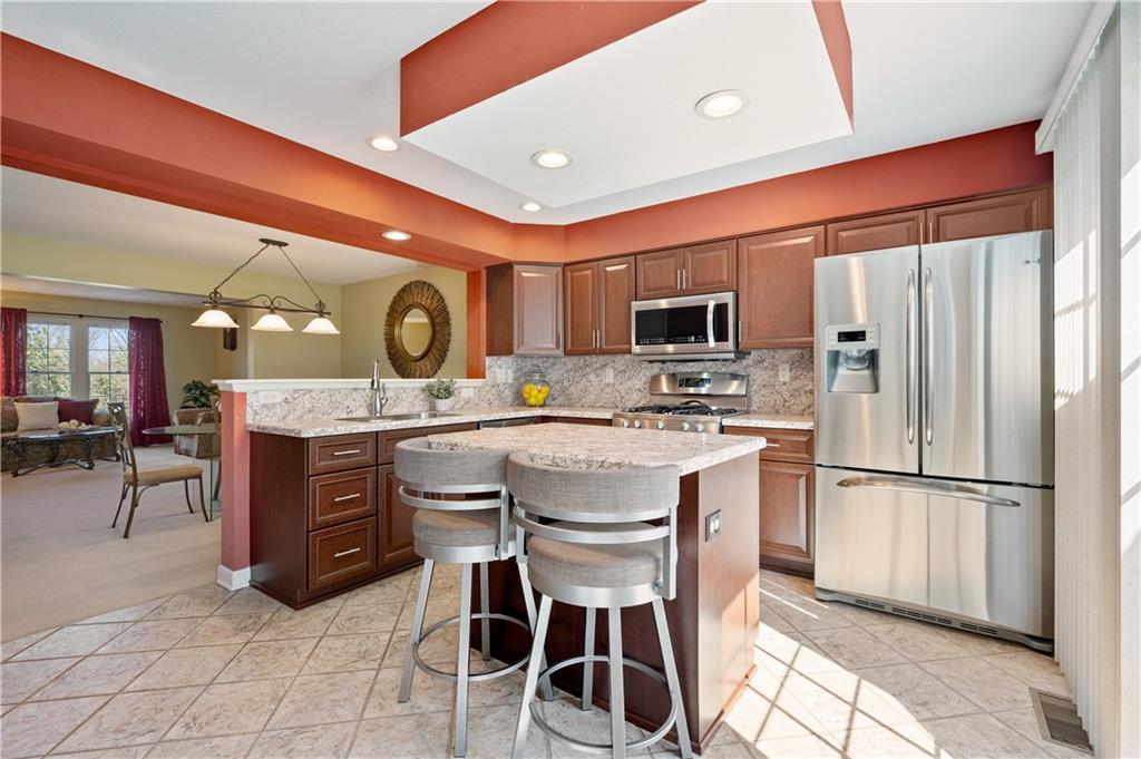 4 Castle View Drive McKees Rocks, PA 15136 - Photo 8 of 20 a kitchen with stainless steel appliances kitchen island granite countertop a table chairs sink and cabinets