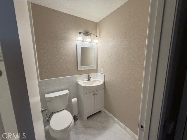 2070 Avenida Placida, Unit 3 Simi Valley, CA 93063 - Photo 14 of 25 a bathroom with a toilet a sink a mirror and vanity