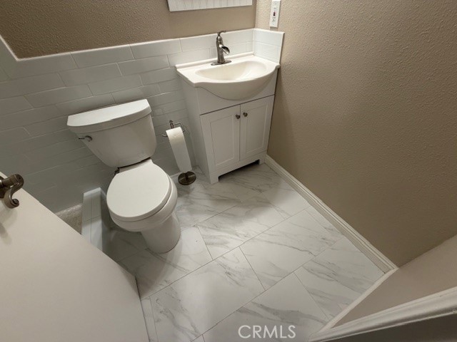 2070 Avenida Placida, Unit 3 Simi Valley, CA 93063 - Photo 16 of 25 a bathroom with a toilet a sink and mirror