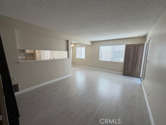 2070 Avenida Placida, Unit 3 Simi Valley, CA 93063 - Photo 3 of 25 an empty room with wooden floor and windows