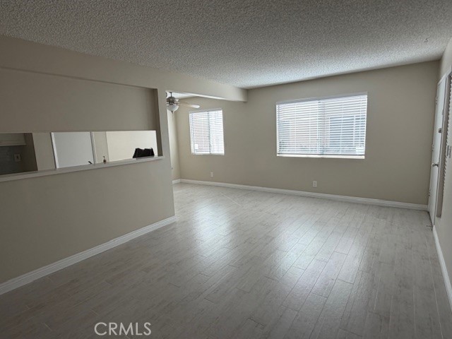 2070 Avenida Placida, Unit 3 Simi Valley, CA 93063 - Photo 4 of 25 an empty room with wooden floor and windows