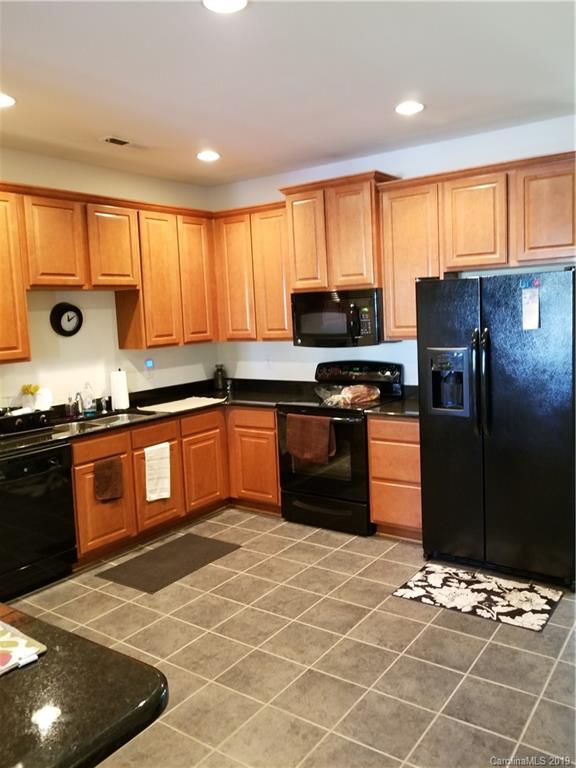5655 Stafford Road Charlotte, NC 28215 - Photo 3 of 13 a kitchen with stainless steel appliances granite countertop a stove a sink dishwasher and a refrigerator