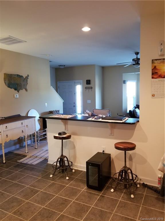 5655 Stafford Road Charlotte, NC 28215 - Photo 6 of 13 a living room with furniture a dining table and chairs