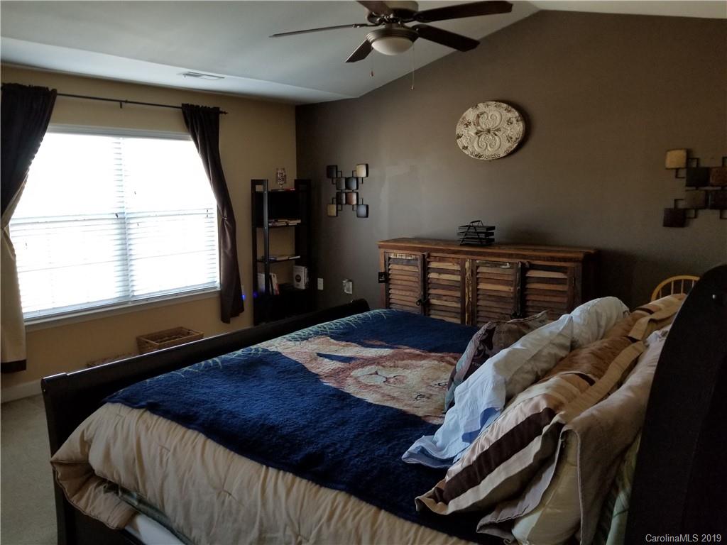 5655 Stafford Road Charlotte, NC 28215 - Photo 8 of 13 a bedroom with a bed and a large window