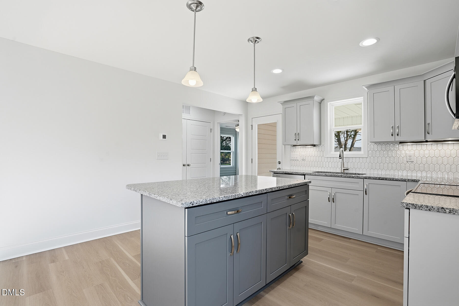 218 Rae Street Warsaw, NC 28398 - Photo 11 of 31 a kitchen with a sink dishwasher and white cabinets with wooden floor