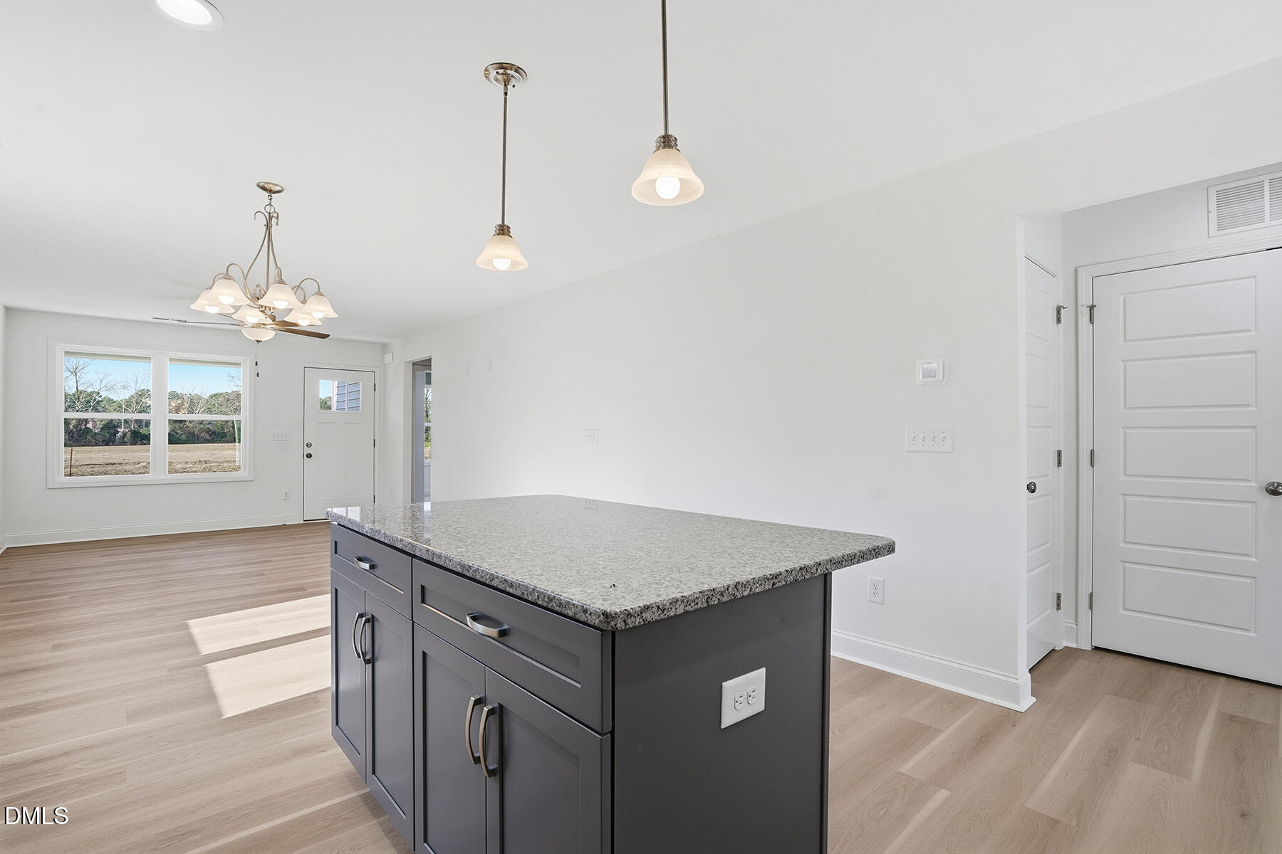 218 Rae Street Warsaw, NC 28398 - Photo 13 of 31 a kitchen with a sink a chandelier and wooden floor