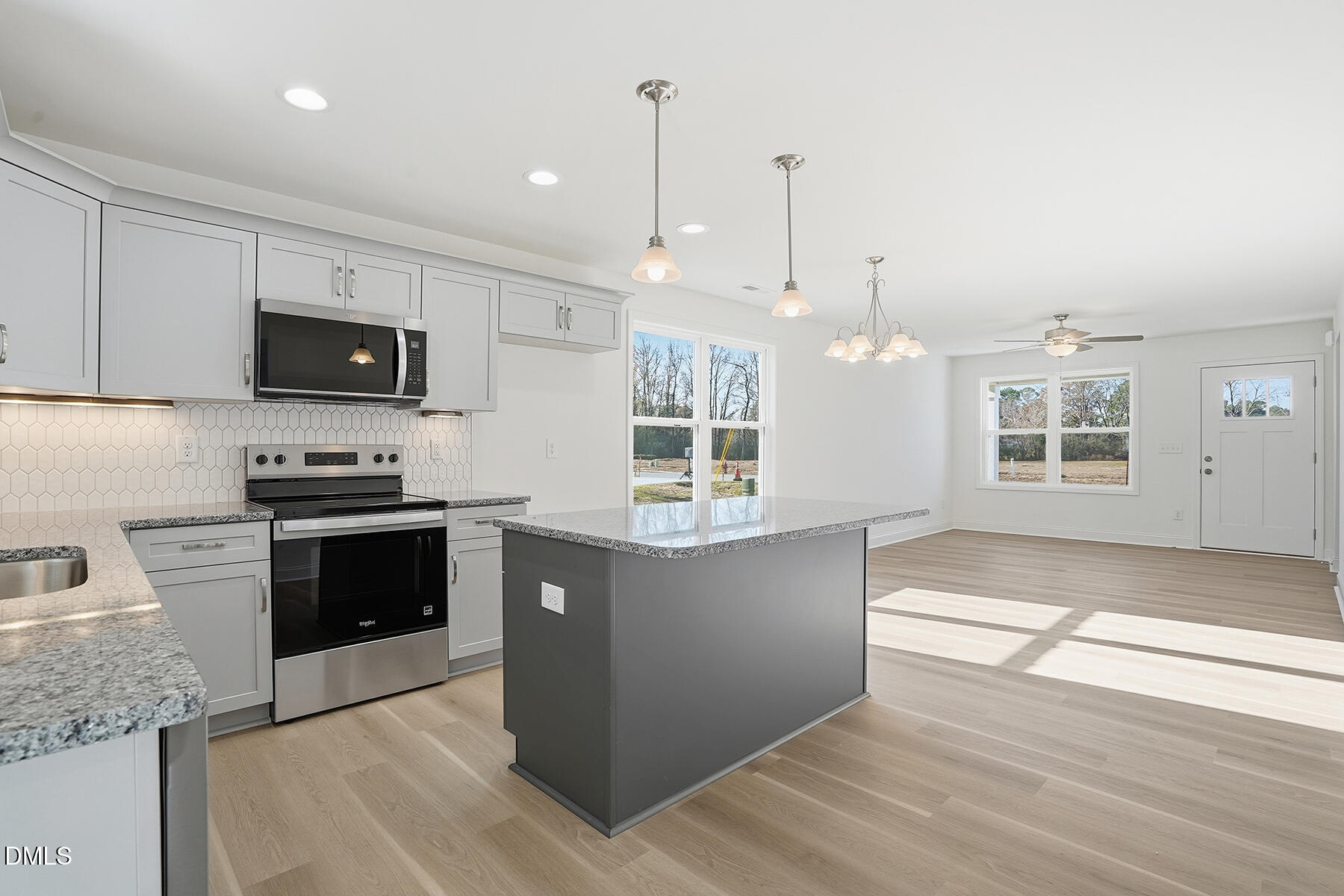 218 Rae Street Warsaw, NC 28398 - Photo 14 of 31 a kitchen with granite countertop a stove a sink and a wooden floors