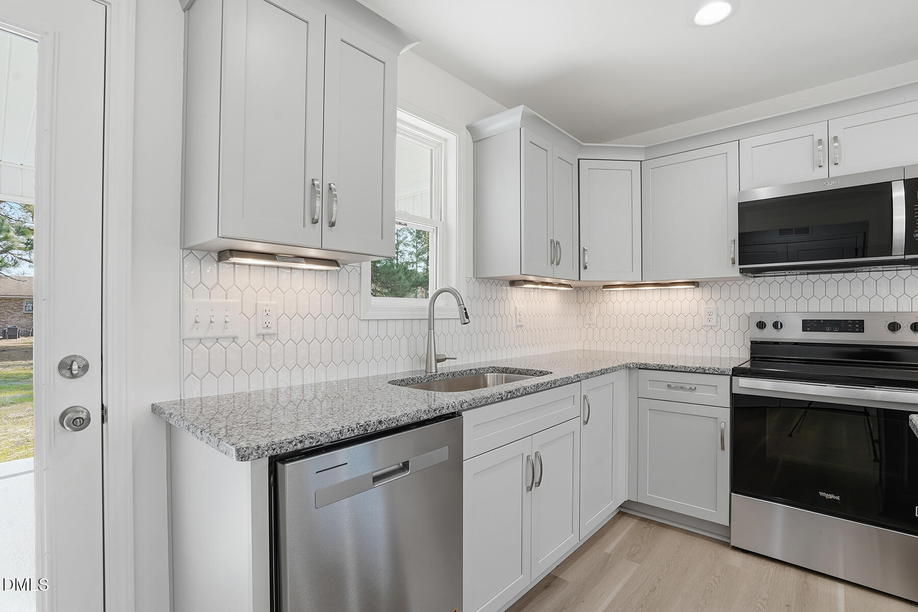 218 Rae Street Warsaw, NC 28398 - Photo 15 of 31 a kitchen with stainless steel appliances granite countertop a sink stove and microwave