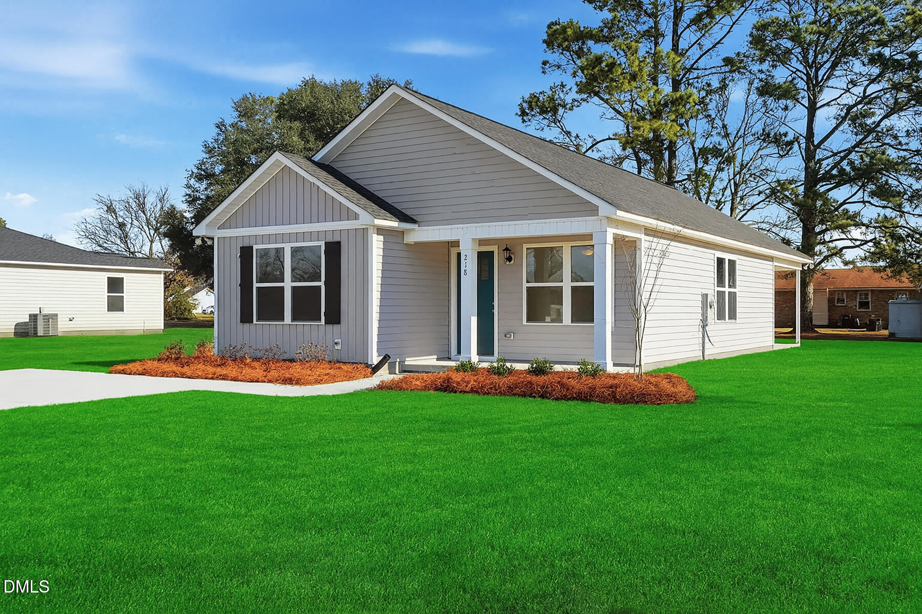 218 Rae Street Warsaw, NC 28398 - Photo 2 of 31 a front view of a house with a garden and yard