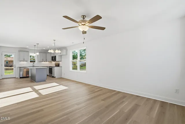 a view of a kitchen with a sink dishwasher and wooden floor