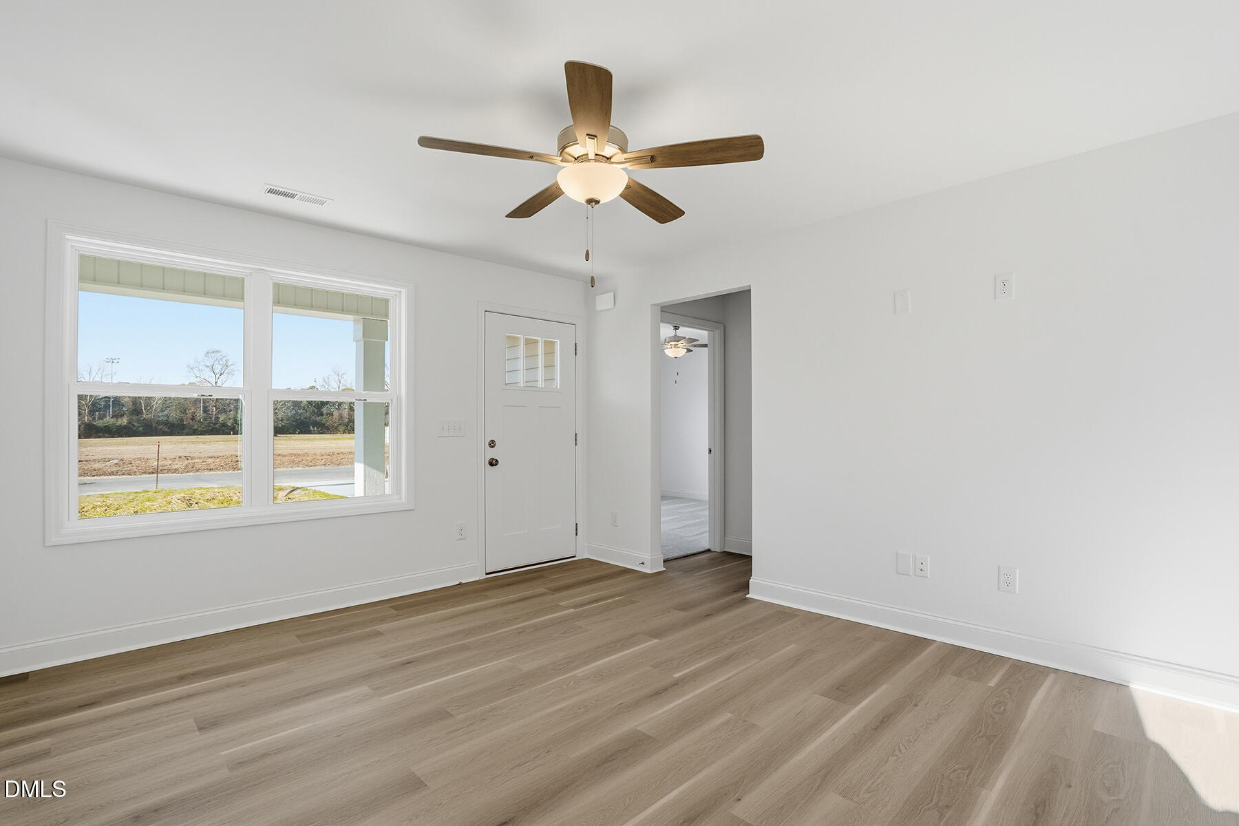 218 Rae Street Warsaw, NC 28398 - Photo 7 of 31 a view of an empty room with wooden floor and a window
