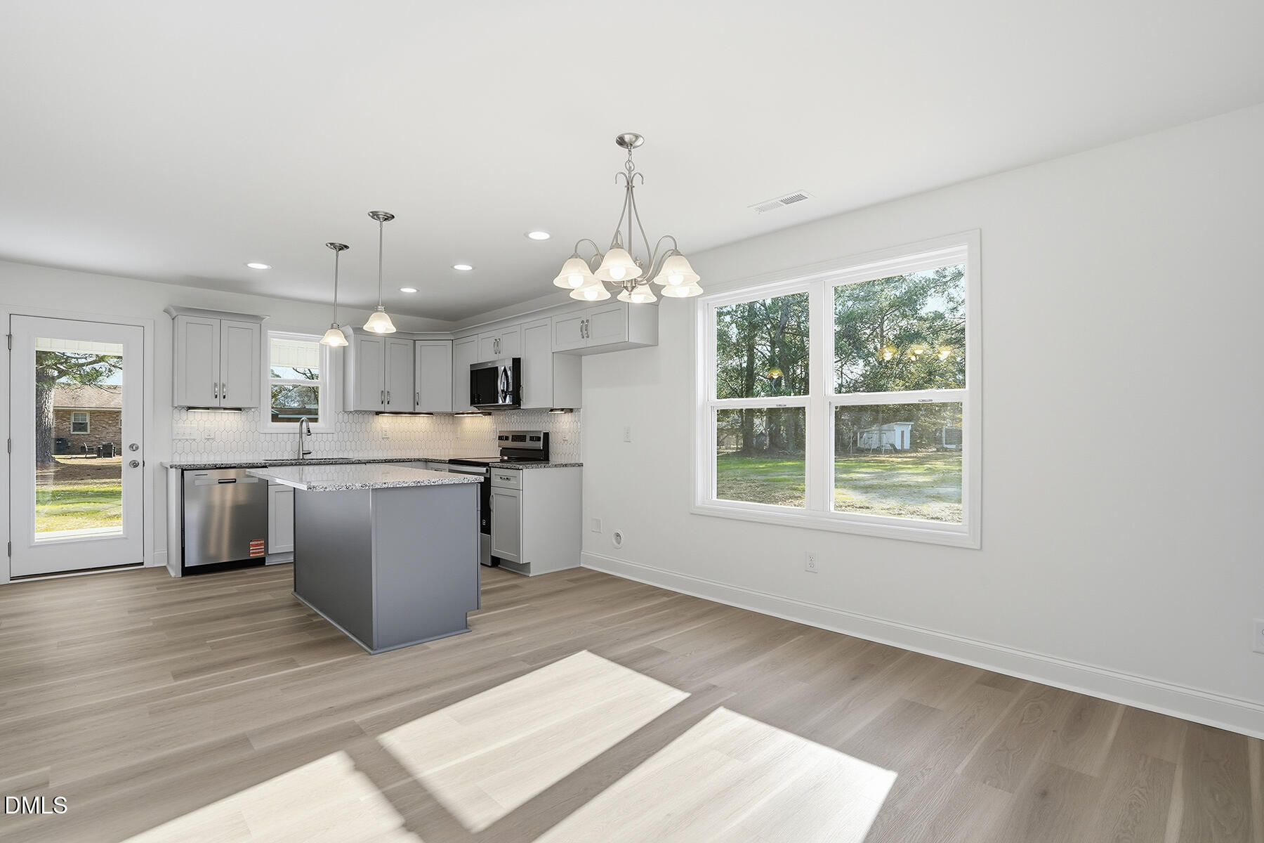 218 Rae Street Warsaw, NC 28398 - Photo 9 of 31 a kitchen with a refrigerator and windows