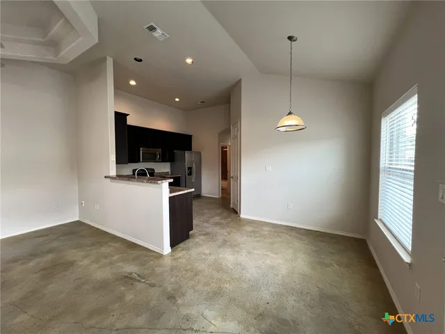 a view of a kitchen with a sink and dishwasher in a room