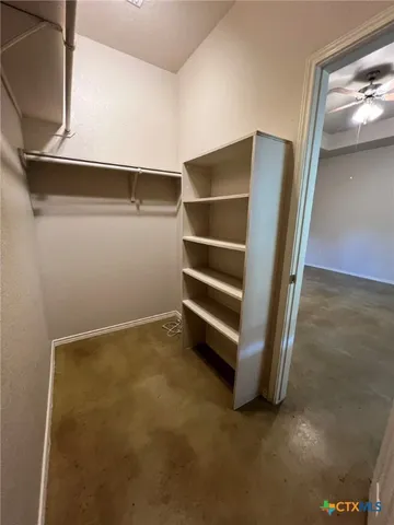 a view of walk in closet with empty racks