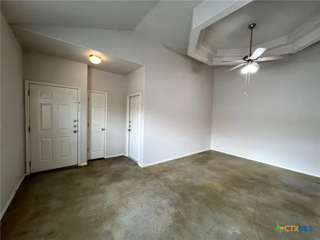 an empty room with fan and fan