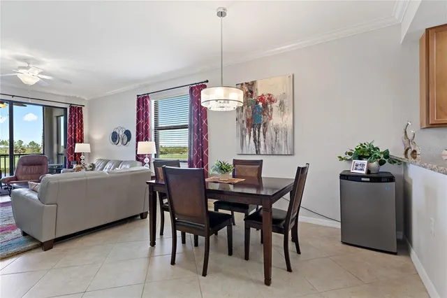 a view of a dining room with furniture and chandelier