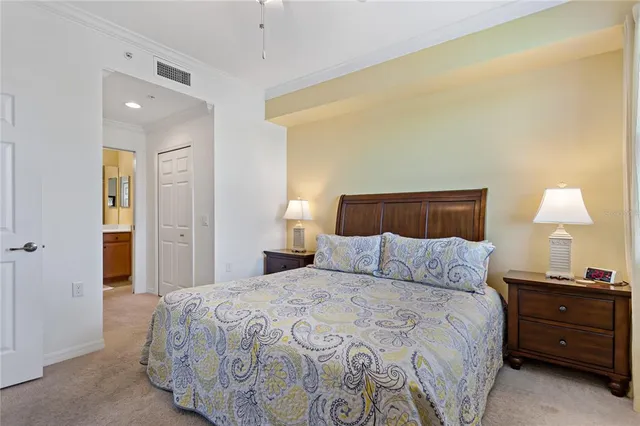 a bedroom with a large bed and a chair