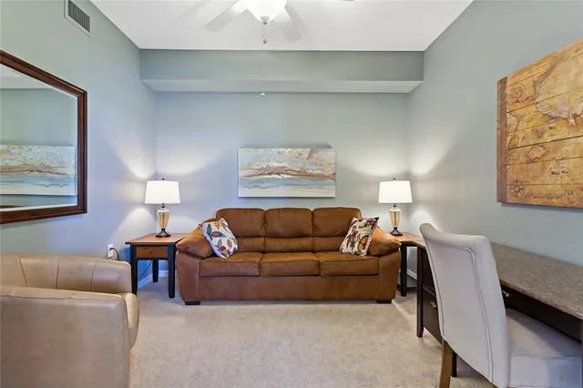 a living room with furniture and cabinets