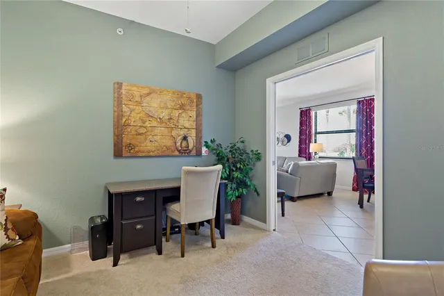 a bedroom with a bed and a potted plant